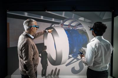 Two people looking at a CAD motor in VR